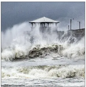  ?? AP/The News & Observer/TRAVIS LONG ?? Ferocious waves generated by Hurricane Florence lash the Oceana Pier and Pier House Restaurant on Thursday in Atlantic Beach, N.C. The center of the storm was still nearly 200 miles offshore.