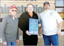  ?? Photograph­s submitted ?? Gary Cowherd, left, and Rodney Robinson, right, of the American Legion presented more than 200 posters to Pea Ridge School superinten­dent Rick Neal recently to place in classrooms following the state’s passage of Act 911.