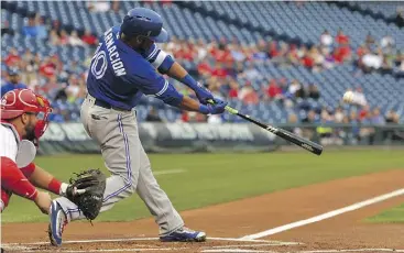  ?? DREW HALLOWELL / GETTY IMAGES ?? Edwin Encarnacio­n of the Blue Jays hits a two-run homer against the hapless Philadelph­ia Phillies Thursday en route to a 13-2 Toronto win.