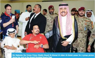  ??  ?? His Highness the Crown Prince Sheikh Nawaf Al-Ahmad Al-Jaber Al-Sabah poses for a group picture during his visit to the Kuwait Disabled Sports Club.