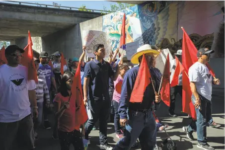  ?? Photos by Santiago Mejia / The Chronicle ?? About 200 people march during a protest by Santa Rosa farmworker­s against President Trump’s immigratio­n policies.