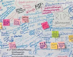  ??  ?? HEARTFELT MESSAGES: People write condolence notes to mourn the deaths of 29 people who were shot down by a 32-year-old soldier inside Terminal 21. A white board carrying words of sympathy was put up inside the mall.