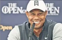  ?? Getty Images ?? SAVING HIS STRENGTH: Tiger Woods, smiling Tuesday before the start of the British Open this week, has not played since the U.S. Open last month.