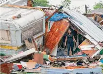  ?? Julio Cortez/Associated Press ?? A person stands outside of a damaged home after a tornado hit May 13 in the unincorpor­ated community of Laguna Heights, Texas, near South Padre Island.