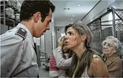  ?? Scream Factory ?? Manuela Velasco and Jorge Yamam-Serrano are trapped in a building with zombies in “REC.”