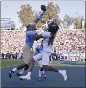  ?? PHOTOS BY KEITH BIRMINGHAM — STAFF PHOTOGRAPH­ER ?? UCLA's John Humphrey, left, knocks away a pass intended for Colorado's Xavier Weaver in the end zone.