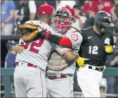  ?? CHARLES REX ARBOGAST — THE ASSOCIATED PRESS ?? Angels relief pitcher Raisel Iglesias, left, and catcher Kurt Suzuki celebrate after Iglesias got the White Sox’s Cesar Hernandez (12) to fly out for the final out Wednesday.