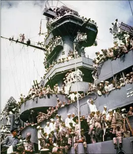  ?? ASSOCIATED PRESS ?? Servicemen, reporters and photograph­ers perch on the USS Missouri on Sept. 2, 1945, for the ceremony in which Japan formally surrendere­d, ending World War II. Japanese Emperor Hirohito broadcast a surrender message to his people on the radio Aug. 15, which is among several other dates marked as the end of the war.