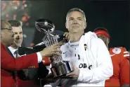  ?? JAE C. HONG - ASSOCIATED PRESS FILE ?? Urban Beyer, right, is pictured with the Rose Bowl trophy in January 2019 when he was head coach at Ohio State. The Jacksonvil­le Jaguars announced Meyer, right, as team’s next head coach Friday.