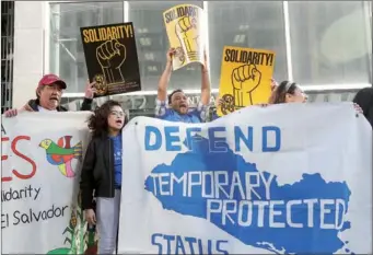  ?? JEFF CHIU / AP ?? Supporters of temporary protected status immigrants hold signs and cheer at a rally before a news conference announcing a lawsuit against the Trump administra­tion over its decision to end a program that lets immigrants live and work legally in the...