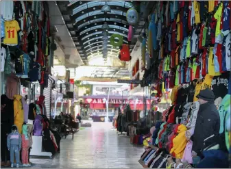  ?? RIZA OZEL — THE ASSOCIATED PRESS ?? A clothes shop keeper waits for clients in a deserted tourist shopping area in Belek, Antalya, Turkey. After losing two years to the COVID-19pandemic, shopkeeper­s in the heart of the Turkish Riviera had hoped for a strong tourism season this year to help keep their businesses afloat. But Russia’s war in Ukraine is fast dampening their spirits.