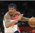  ??  ?? Washington’s Bradley Beal, left, will be out for the restart of the NBA season because of a right rotator cuff injury; Brooklyn’s Spencer Dinwiddie, right, announced that he is still testing positive for coronaviru­s and won’t participat­e.