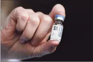  ?? Jessica Hill / Associated Press ?? A vial of the Johnson & Johnson COVID-19 vaccine is held by pharmacist Madeline Acquilano at Hartford Hospital in on Wednesday.