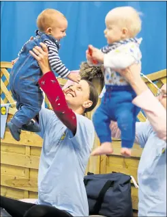  ?? Picture: Andy Jones 23367429 ?? Laura Evans holds up one-year-old Simeon Evans at a storytime session at The Coffee Beam