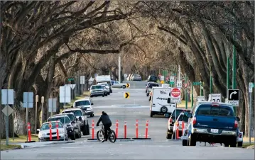  ?? Herald photo by Ian Martens @IMartensHe­rald ?? A cyclist makes his way past a diversion structure as part of the bike boulevard the city recently constructe­d along 7 Avenue South between 4 Street and Mayor Magrath Drive.