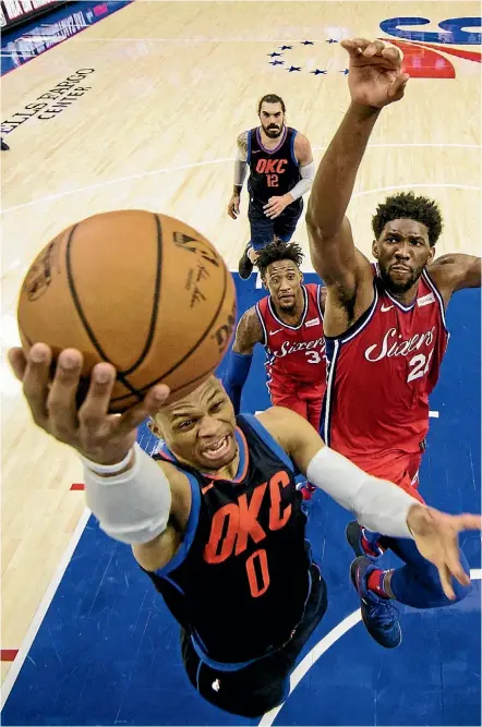  ??  ?? Oklahoma City’s Russell Westbrook attacks the basket during a tight win over Philadelph­ia yesterday.