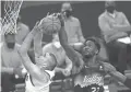  ?? PATRICK BREEN/ARIZONA REPUBLIC ?? The Suns’ Deandre Ayton (22) blocks a shot from the Nuggets’ Nikola Jokic.