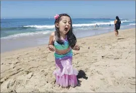  ?? Christina House Los Angeles Times ?? JAMIE Brooks Arreola, 3, of Cerritos plays at Seal Beach, her first visit to a beach since the lockdown. All states have reopened in some fashion this week.