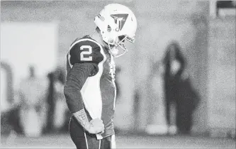  ?? PAUL CHIASSON THE CANADIAN PRESS ?? Alouettes quarterbac­k Johnny Manziel pauses during third-quarter CFL action against the Hamilton Tiger-Cats in Montreal on Friday night. Manziel's much-anticipate­d CFL debut fizzled quickly.