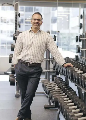  ?? IAN KUCERAK ?? Aspen Properties general manager Morley Barr checks out the free weights in the brandnew, yet-to-be-opened Jackson’s Gym in Bell Tower. The original site, opened in 1923, is considered the oldest private fitness club in Canada.