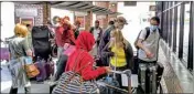  ?? PTI ?? Stranded American tourists arrive at the at the internatio­nal airport to board a special repatriati­on flight back to US, in Kathmandu, Nepal, Sunday