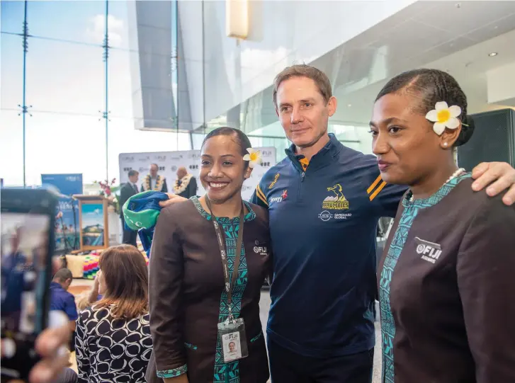  ?? Photo: Leon Lord. ?? Former Australian Wallaby and Brumbies great Stephen Larkham with Fiji Airways cabin crew during the official announceme­nt of the Fiji- Canberra direct flight at the Canberra Airport in Australia on April 14,2023. Also, it was confirmed at the announceme­nt that Fiji Airways is the official sponsor of the Brumbies where Larkham is the current head coach. Report on pages 26-27.