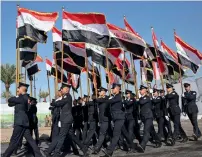  ?? AFP ?? Members of the honorary guard of Iraq’s Rapid Response military unit take part in a parade at a military base inside Baghdad’s Internatio­nal Airport to mark the first anniversar­y of the country’s victory over the Daesh group. —