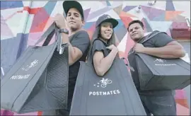 ?? Myung J. Chun Los Angeles Times ?? POSTMATES rents a commissary kitchen in L.A. where a ramen restaurant cooks food that is delivered solely by the firm, which takes a sales commission. Above, Gus Peroba, left, Demiries Mendez and Gabriel Figueroa are couriers.