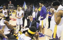  ?? Carlos Avila Gonzalez / The Chronicle ?? Warriors players gather around head coach Steve Kerr as he draws up a play during a timeout in a game against the Minnesota Timberwolv­es at Oracle Arena on April 4.