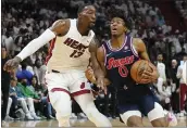  ?? MARTA LAVANDIER — THE ASSOCIATED PRESS ?? Philadelph­ia 76ers guard Tyrese Maxey (0) drives to the basket as Miami Heat center Bam Adebayo (13) defends during the first half Wednesday.