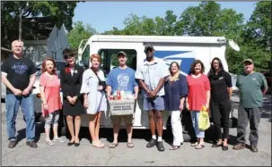  ?? The Sentinel-Record/Rebekah Hedges ?? FOOD DRIVE: Representa­tives from six beneficiar­y organizati­ons gathered on Wednesday with U.S. Postal Service workers Kevin Hooper and Ed Rice in front of a service vehicle to promote Saturday’s 26th annual “Stamp Out Hunger” food drive.