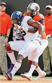  ?? [PHOTO BY NATE BILLINGS, THE OKLAHOMAN] ?? TCU’s John Diarse catches a touchdown in front of Oklahoma State cornerback Rodarius Williams last week at Boone Pickens Stadium in Stillwater.