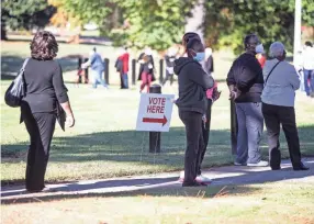  ?? ARIEL COBBERT/THE COMMERCIAL APPEAL ?? People wait in line to vote at the Glenview Community Center during the first day of early voting in Memphis, Tenn., on October 14, 2020.