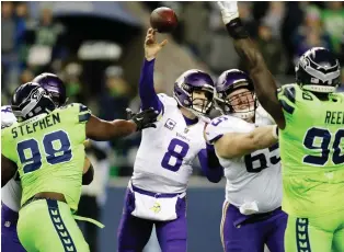  ?? STEPHEN BRASHEAR/THE ASSOCIATED PRESS ?? Vikings quarterbac­k Kirk Cousins delivers a pass while under pressure from onrushing Seahawks defenders during Monday night’s contest in Seattle. The Seahawks won 21-7.
