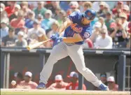  ?? Brynn Anderson / Associated Press ?? The New York Mets cut former NFL quarterbac­k Tim Tebow from spring training camp on Tuesday and re-assigned him to the minor leagues. Tebow finished spring training playing left field and went 4 for 15 with an RBI in eight games.