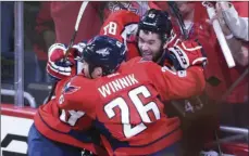  ?? PHOTO/MOLLY RILEY ?? Washington Capitals right wing Tom Wilson (43) celebrates his overtime goal with center Jay Beagle (83) and left wing Daniel Winnik (26) against the Toronto Maple Leafs during Game 1 of an NHL hockey Stanley Cup first-round playoff series in Washington...