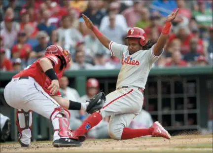  ?? NICK WASS — THE ASSOCIATED PRESS ?? Philadelph­ia Phillies’ Maikel Franco, right, slides home to score during the seventh inning of a baseball game against Washington Nationals catcher Spencer Kieboom, left, Saturday in Washington. The Phillies won 5-3.