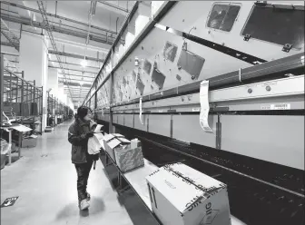  ?? JI HAIXIN / FOR CHINA DAILY ?? A Nike employee works at a production facility in Taicang, Jiangsu province.