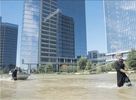  ?? ERICH SCHLEGEL/GETTY IMAGES ?? Rescuers from Odessa, Texas, make their way along Eldridge Parkway in west Houston on Wednesday. Tropical Storm Harvey has shut down many oil refineries on the U.S. Gulf Coast and could have a larger impact on Canadian oil producers.