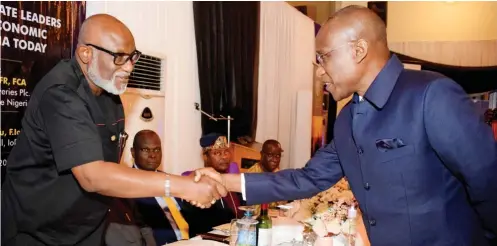  ??  ?? From right: Managing Director/CEO, Asset Management Corporatio­n of Nigeria (AMCON), Mr. Ahmed Kuru in a handshake with the Ondo State Governor, Mr. Oluwarotim­i Akeredolu, SAN shortly before the investitur­e of Kuru as a Fellow of IoD…recently