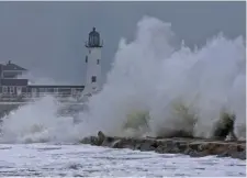  ?? MATT STOnE / bOSTOn hERALD ?? COLD AND WET: Waves crash near Scituate Light during nor’easter on Wednesday.