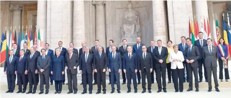  ?? — AFP ?? EU leaders pose for a family photo during a special summit to mark the 60th anniversar­y of the bloc’s founding Treaty of Rome on Saturday at Rome’s Piazza del Campidogli­o (Capitoline Hill).