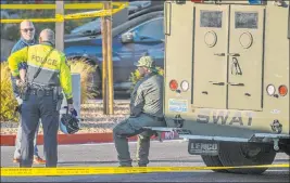  ?? L.E. Baskow Las Vegas Review-journal @Left_eye_images ?? Emergency personnel wait at a SWAT vehicle after four were killed and one injured in a police shooting at The Douglas at Stonelake Apartments on Nov. 3.