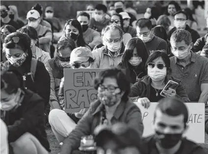  ?? Yi-Chin Lee / Staff photograph­er ?? People take a moment of silence while participat­ing in a “Stop Asian Hate” vigil and rally to mourn the six Asian American victims killed in Atlanta and denounce a rise in violence targeting Asian Americans on Saturday at Discovery Green.