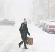  ?? RYAN REMIORZ / THE CANADIAN PRESS ?? Shoppers like this Montreal woman may be out buying, but savings rates are going up, David Rosenberg writes.