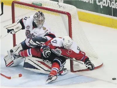  ??  ?? Victoria Royals’ Matthew Phillips runs into Regina Pats goaltender Tyler Brown during their WHL game at Save-on-Foods Memorial Centre on Saturday.