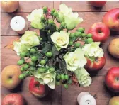  ??  ?? Setting up as much as possible ahead of time, such as flowers and little touches like fresh apples on a table, gives you a real leg up when it comes to getting the meal on the table Thanksgivi­ng Day.