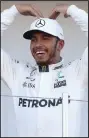  ??  ?? Lewis Hamilton celebrates on the podium after his victory
