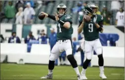  ?? MATT ROURKE — THE ASSOCIATED PRESS ?? Philadelph­ia Eagles quarterbac­ks Carson Wentz (11) and Nick Foles (9) throw before a game against the Colts earlier this season. Wentz’s back injury will give Foles another opportunit­y as the reigning Super Bowl MVP will get the start for the Eagles Sunday against the Los Angeles Rams.