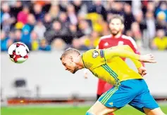  ??  ?? Sweden’s forward Marcus Berg heads the ball to score a goal during the FIFA World Cup 2018 qualifying match between Sweden and Luxembourg in Solna, north of the capital Stockholm on October 7, 2017. - AFP photo